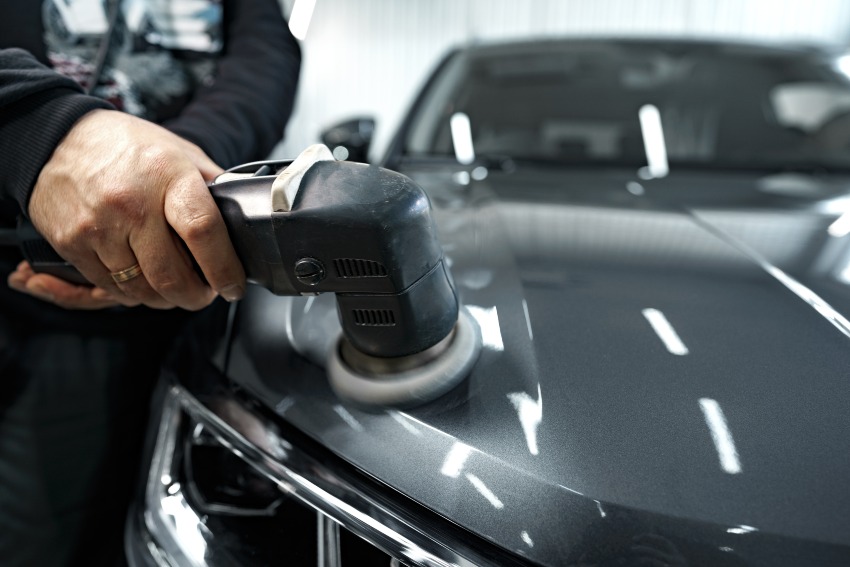 A man polishing a car, emphasizing service by Auto Salon of Orlando in Orlando, FL