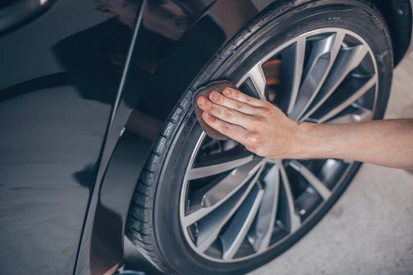 A wheel detailing service on a black vehicle at Auto Salon of Orland in Orlando, FL